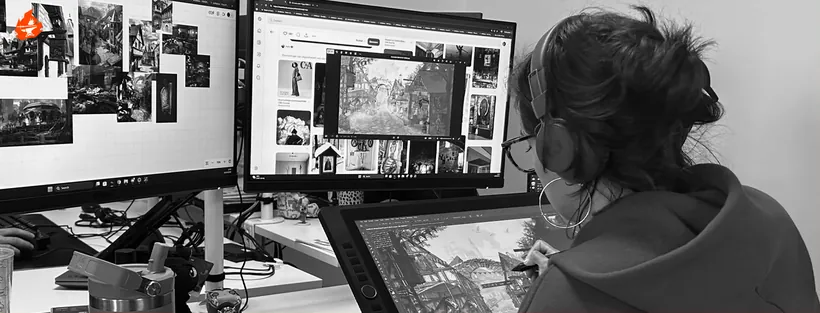 An artist painting an environment with reference images around her
